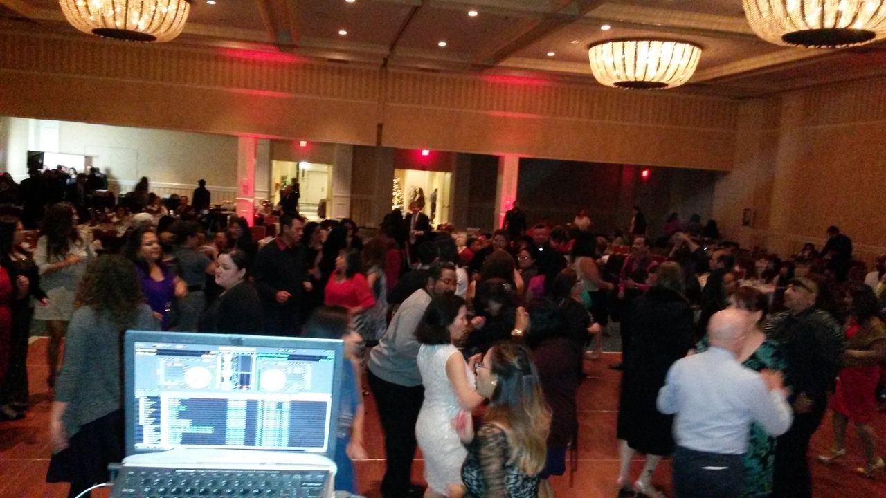 Our Event Dj Services for a 300 plus dance in a ballroom with chandeliers. A DJ, lighting and corporate games.