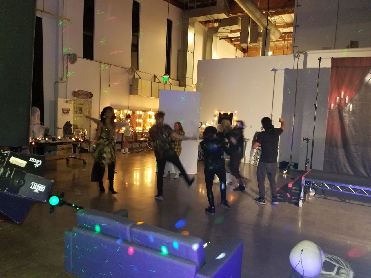 A Hollywood studio wrap party dj with a Halloween theme being it was late October and the set up crew testing the dance floor before party officially starts.